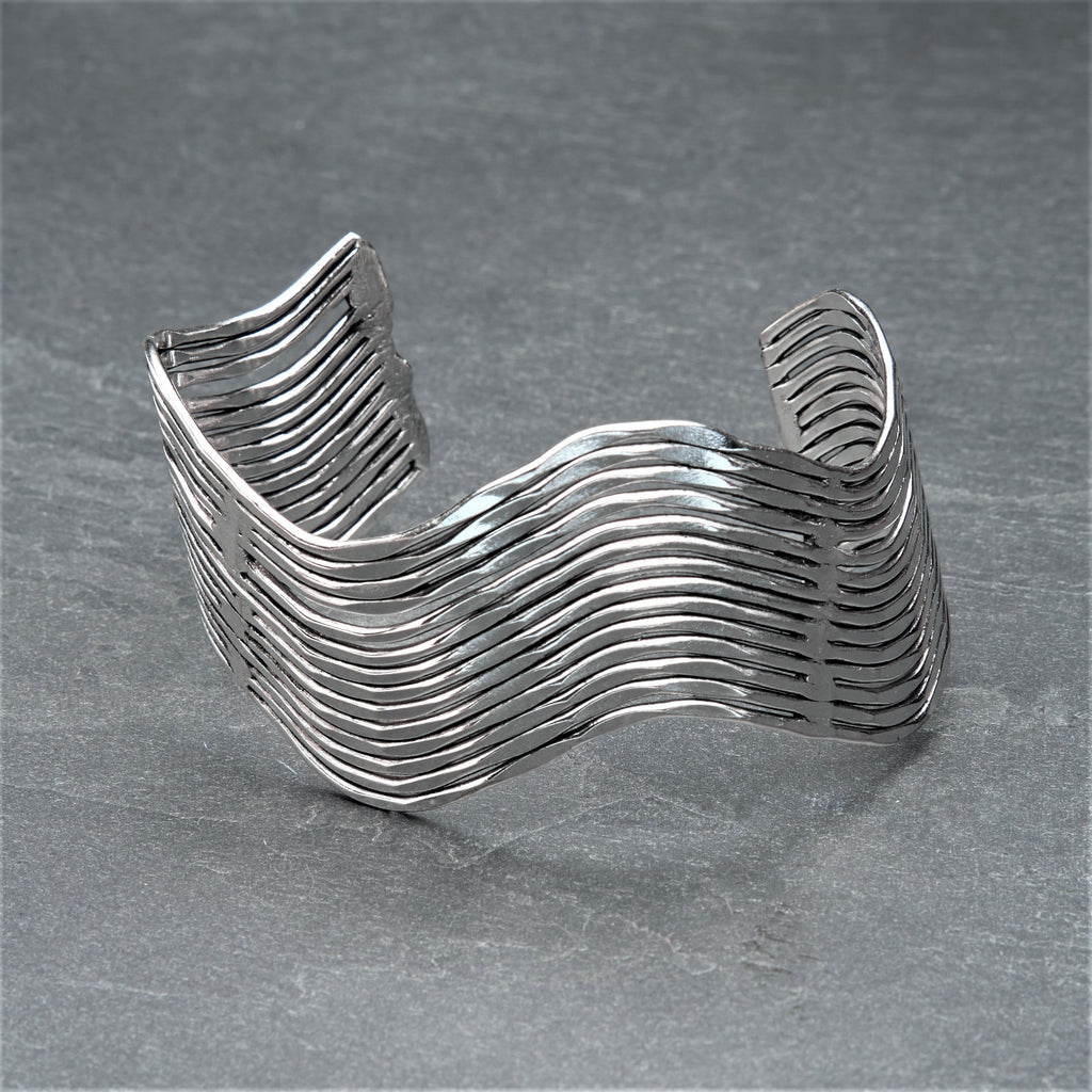 An adjustable, solid silver wavy cuff bracelet designed by OMishka.