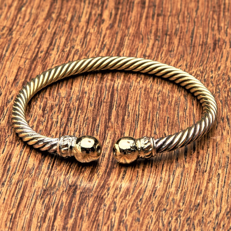 An adjustable, twisted pure brass rope cuff bracelet designed by OMishka.