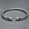 An adjustable, twisted silver rope cuff bracelet designed by OMishka.