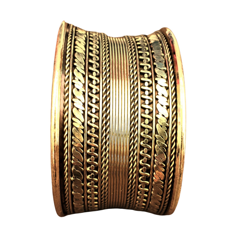 An adjustable, wide pure brass striped concave cuff designed by OMishka.