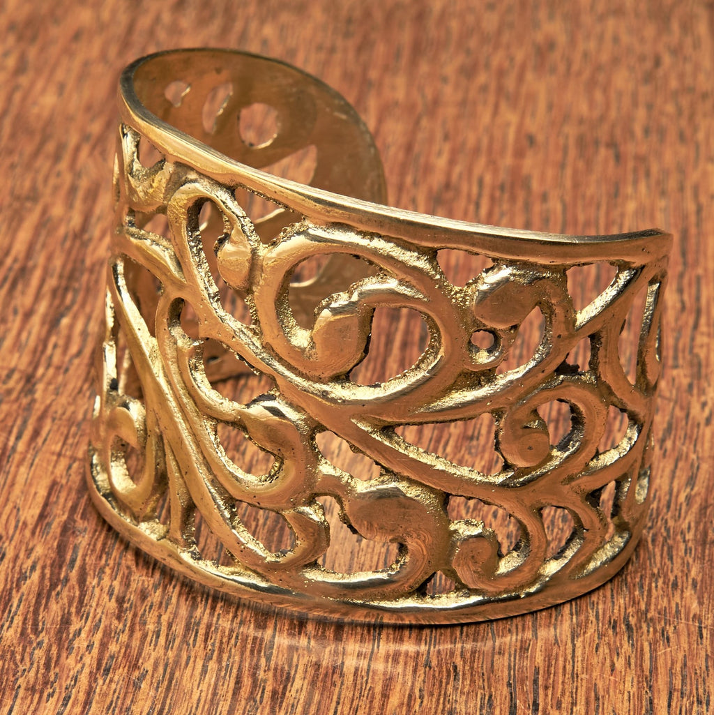 An adjustable, wide chunky pure brass open floral patterned cuff bracelet designed by OMishka.