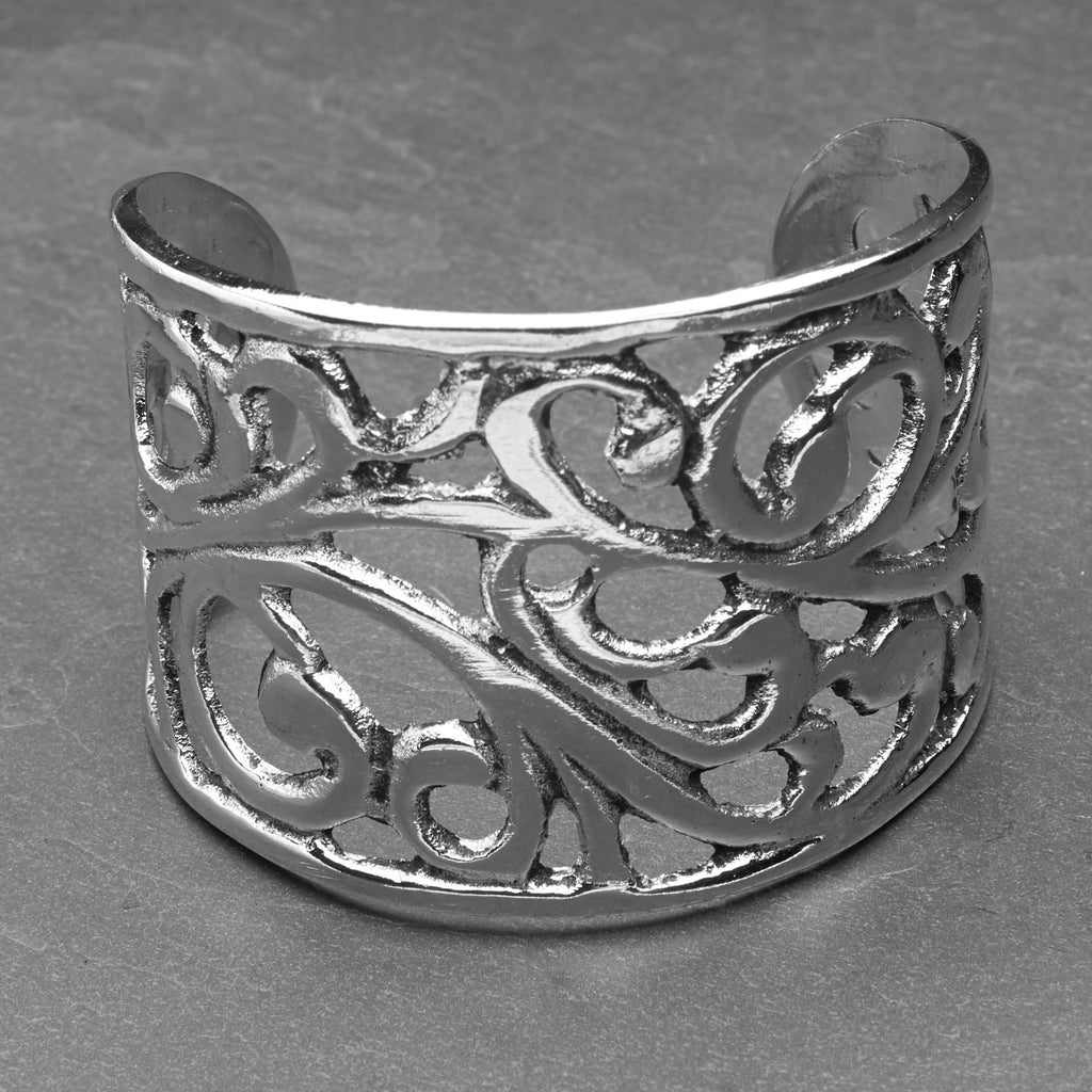An adjustable, wide chunky silver open floral patterned cuff bracelet designed by OMishka.