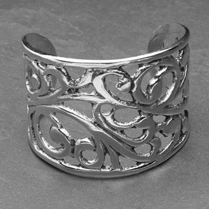 An adjustable, wide chunky silver open floral patterned cuff bracelet designed by OMishka.