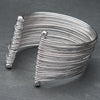 An adjustable, wide silver multi strand bracelet designed by OMishka.