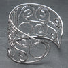 An adjustable wide, silver spiral patterned open bracelet designed by OMishka.