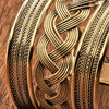 An adjustable, wide woven patterned pure brass open cuff bracelet designed by OMishka.