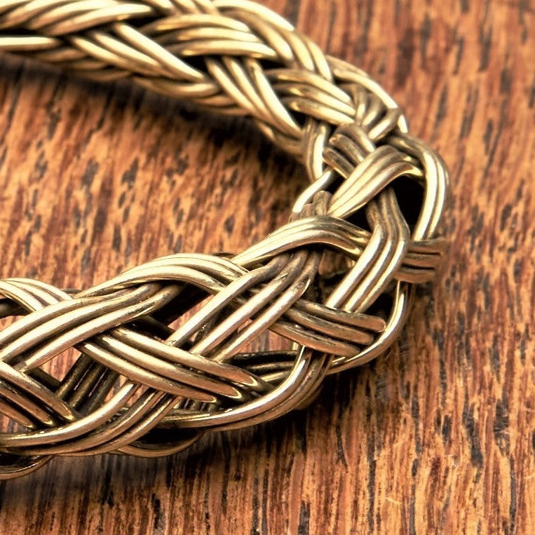 An adjustable woven, pure brass braid cuff bracelet designed by OMishka.