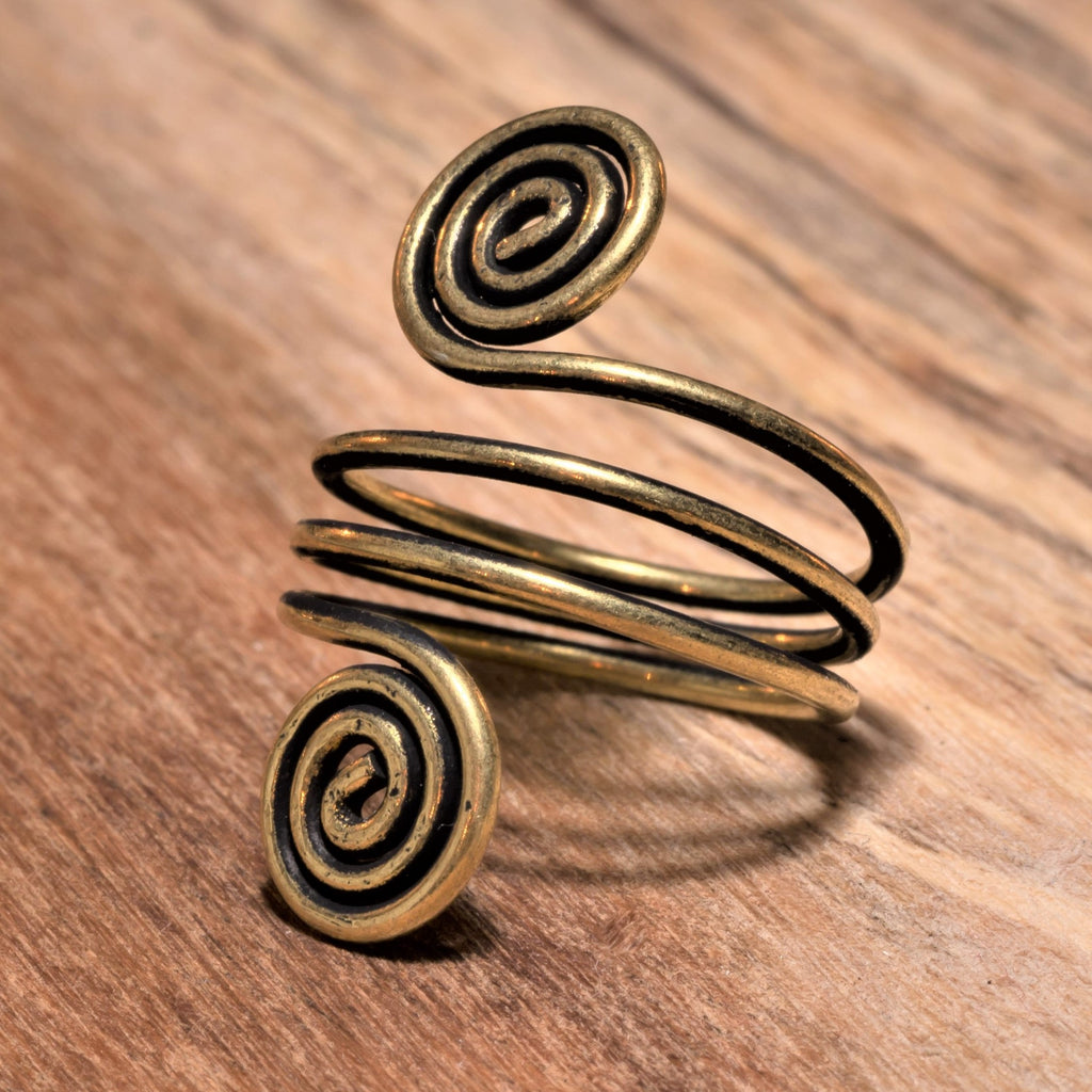 An artisan handmade, adjustable triple wrap, pure brass open spiral toe ring designed by OMishka.