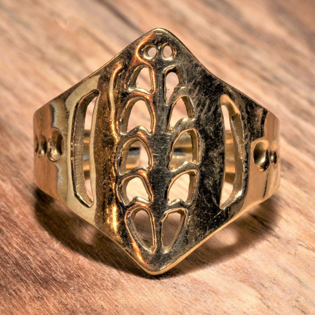 An artisan handmade, adjustable, pure brass tribal shield ring designed by OMishka.
