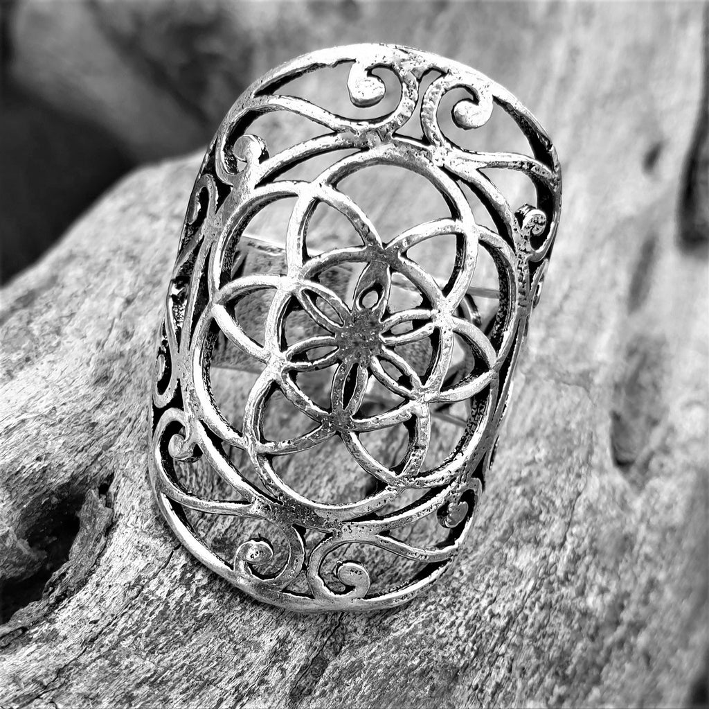 A chunky, artisan handmade, solid silver, decorative seed of life ring designed by OMishka.