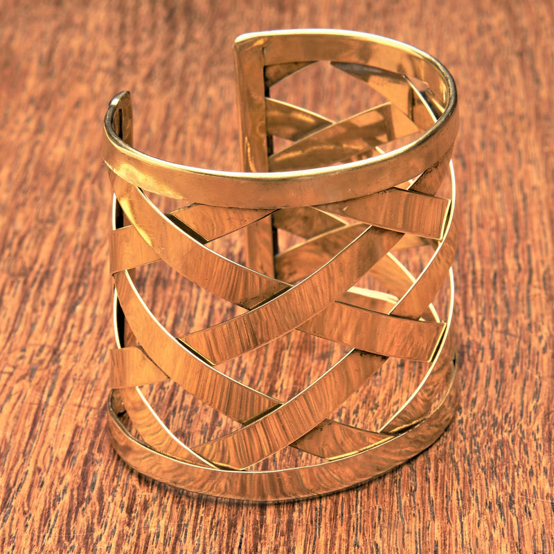 A wide artisan handmade pure brass, open lattice criss cross detailed cuff bracelet designed by OMishka.