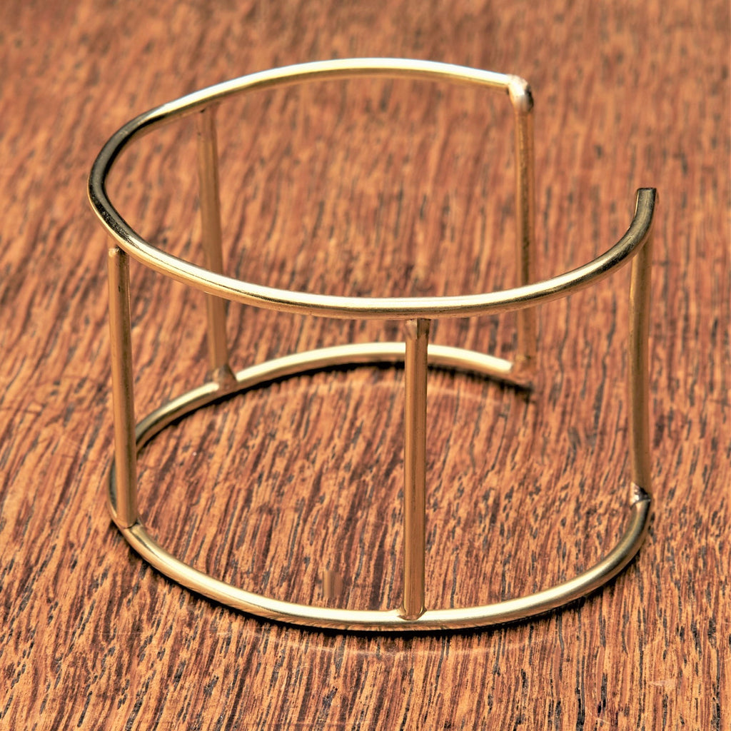An artisan handmade pure brass, cut out square shaped cuff designed by OMishka.