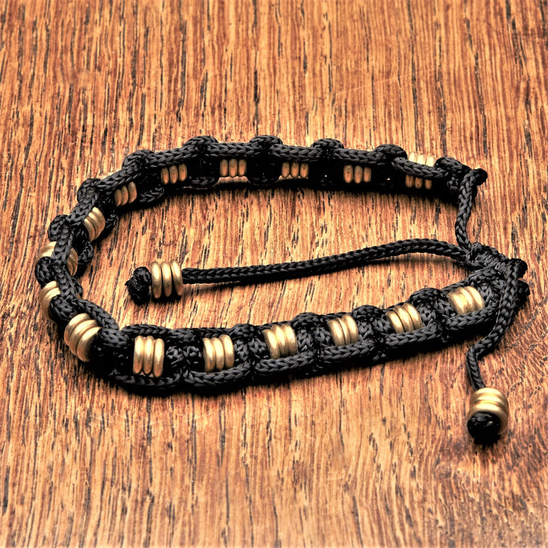 Artisan handmade pure brass disc beaded, woven black hemp cord adjustable bracelet designed by OMishka.