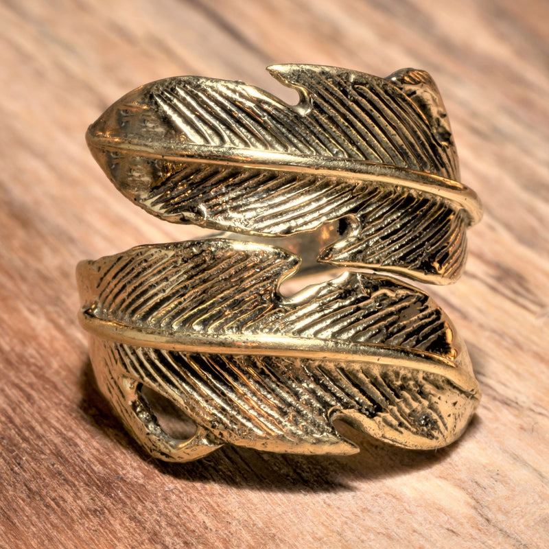 An adjustable, artisan handmade pure brass, double feather wrap ring designed by OMishka.