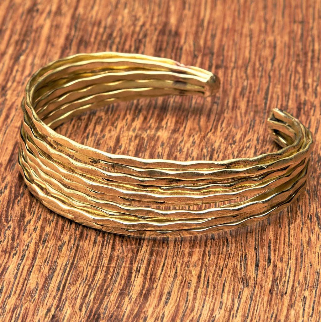 An artisan handmade pure brass, multi stacked cuff bracelet designed by OMishka.