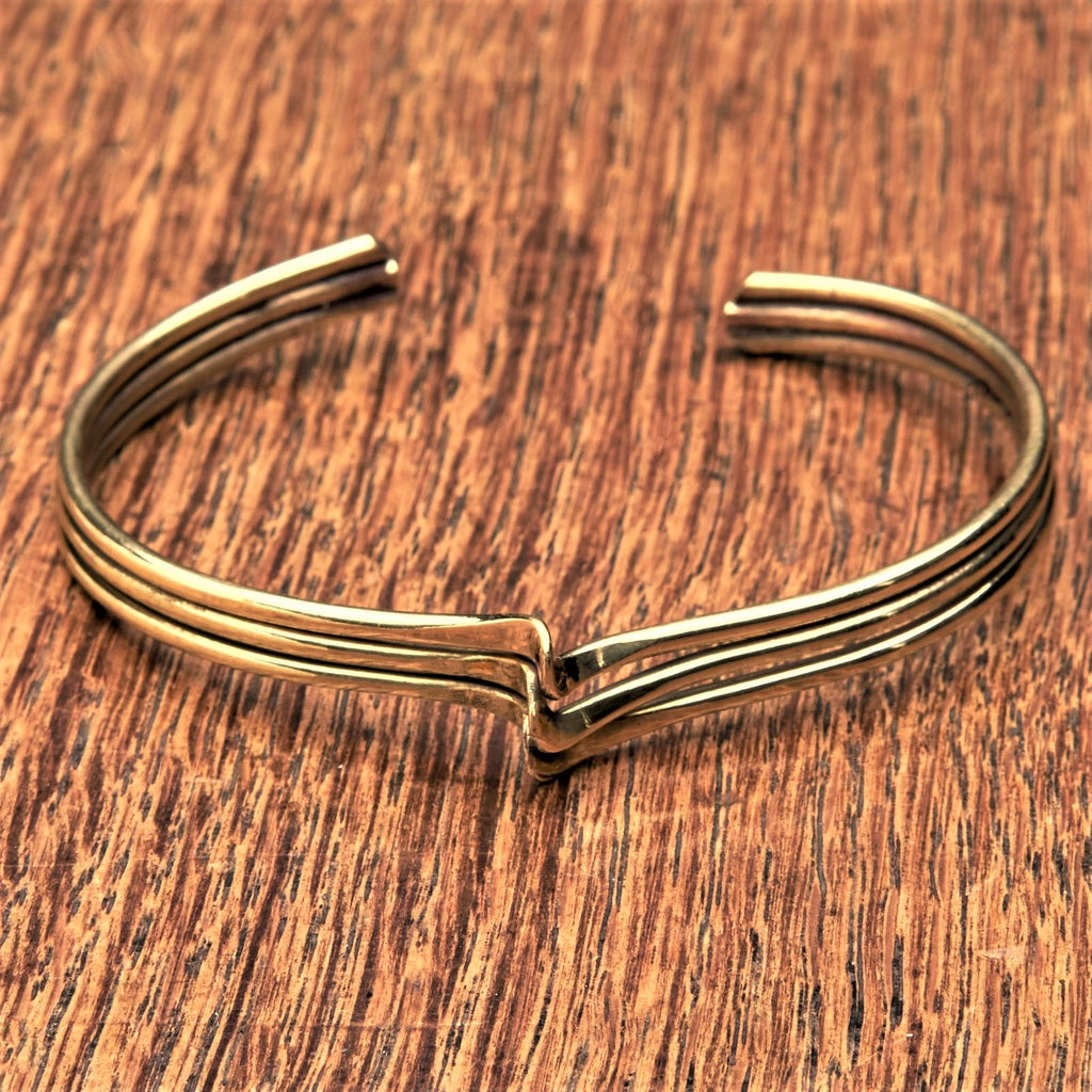 An artisan handmade, pure brass triple wave bracelet designed by OMishka.