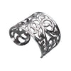 An artisan handmade, chunky silver open floral patterned wide cuff designed by OMishka.