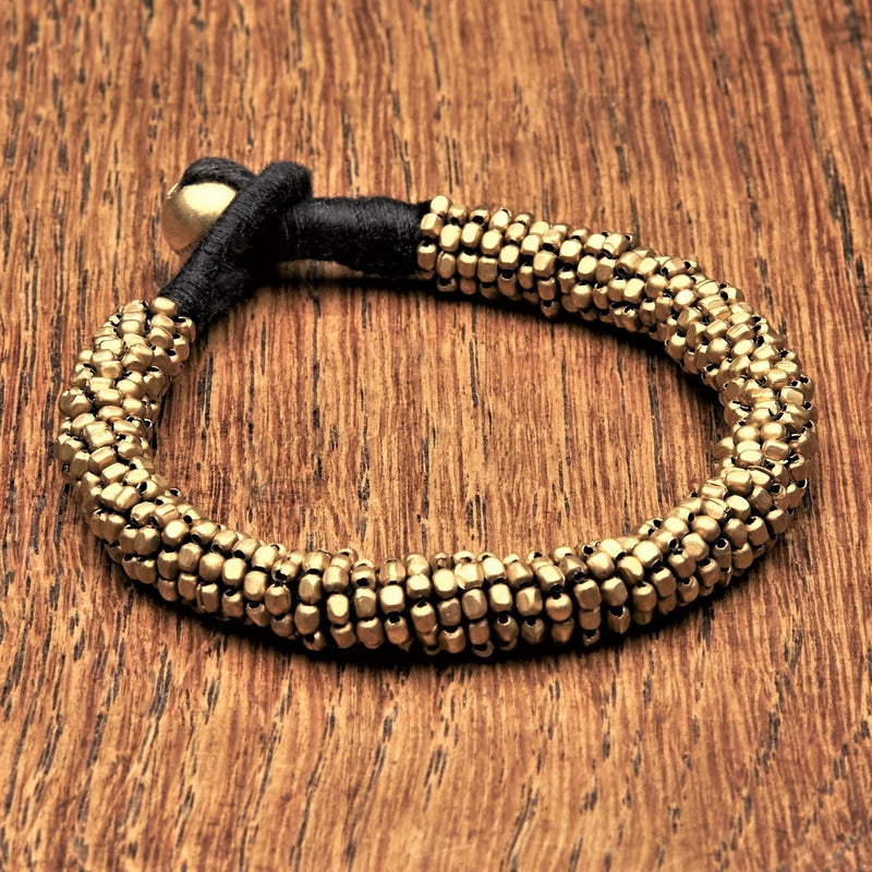 Artisan handmade, slim coiled pure brass beaded bracelet with a bead and hoop closure, designed by OMishka.
