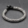 Artisan handmade, slim coiled silver beaded bracelet with a bead and hoop closure, designed by OMishka.