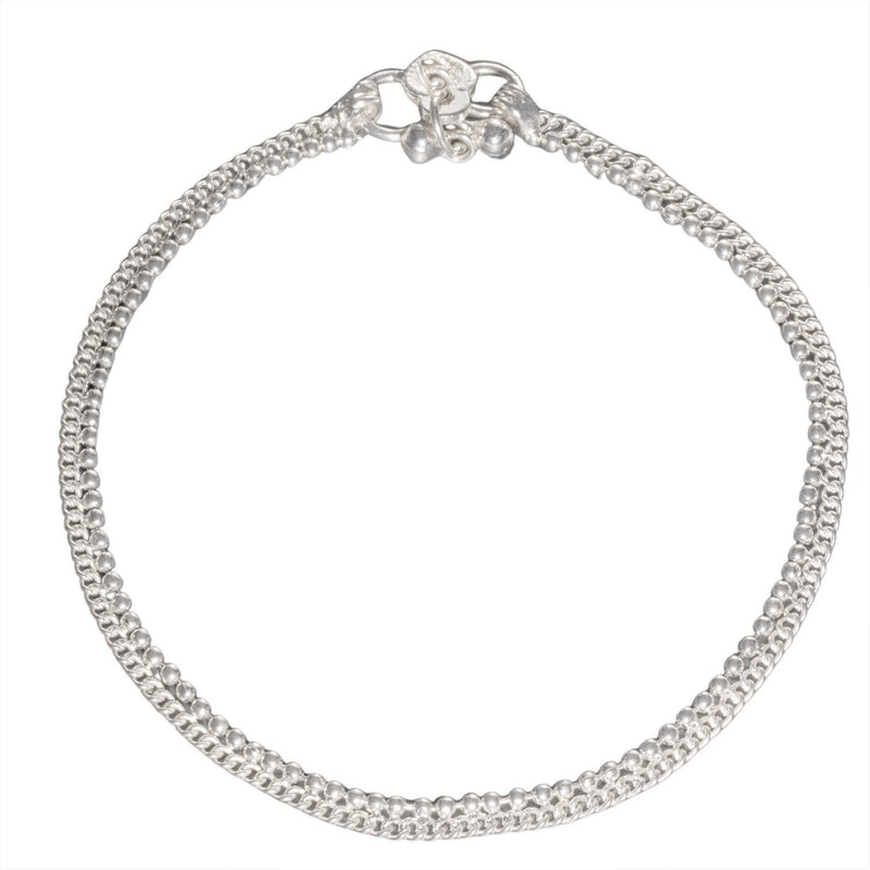 An artisan handmade, dainty solid silver beaded ankle chain designed by OMishka.