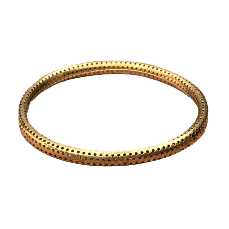 An artisan handmade, hollow, dotted pure brass bangle bracelet designed by OMishka.