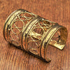 An artisan handmade extra wide, pure brass, open circle patterned cuff bracelet designed by OMishka.