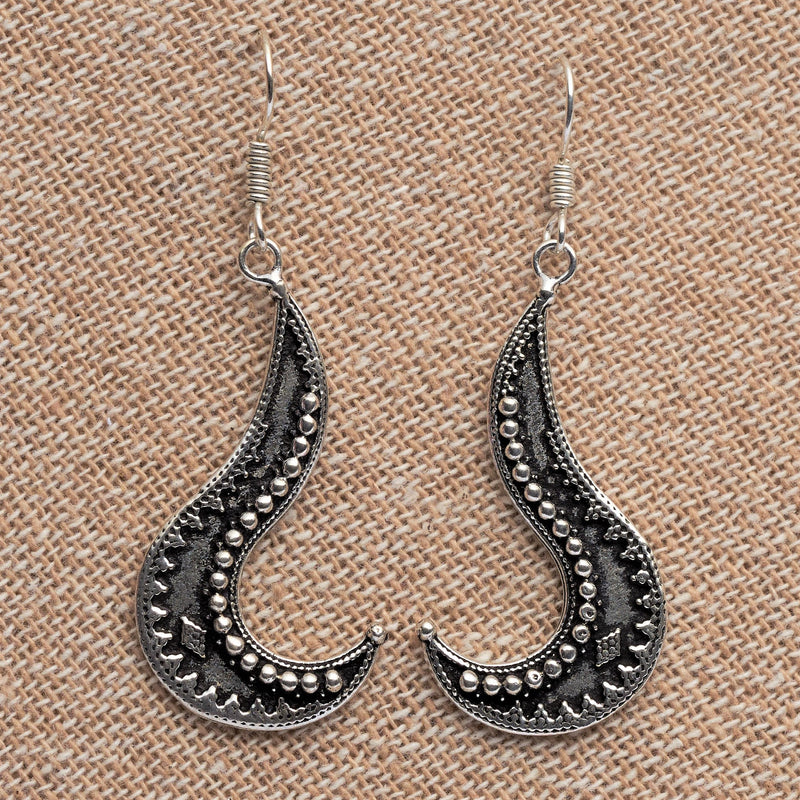Artisan handmade solid silver, tribal patterned, long swirl shaped dangle earrings designed by OMishka.