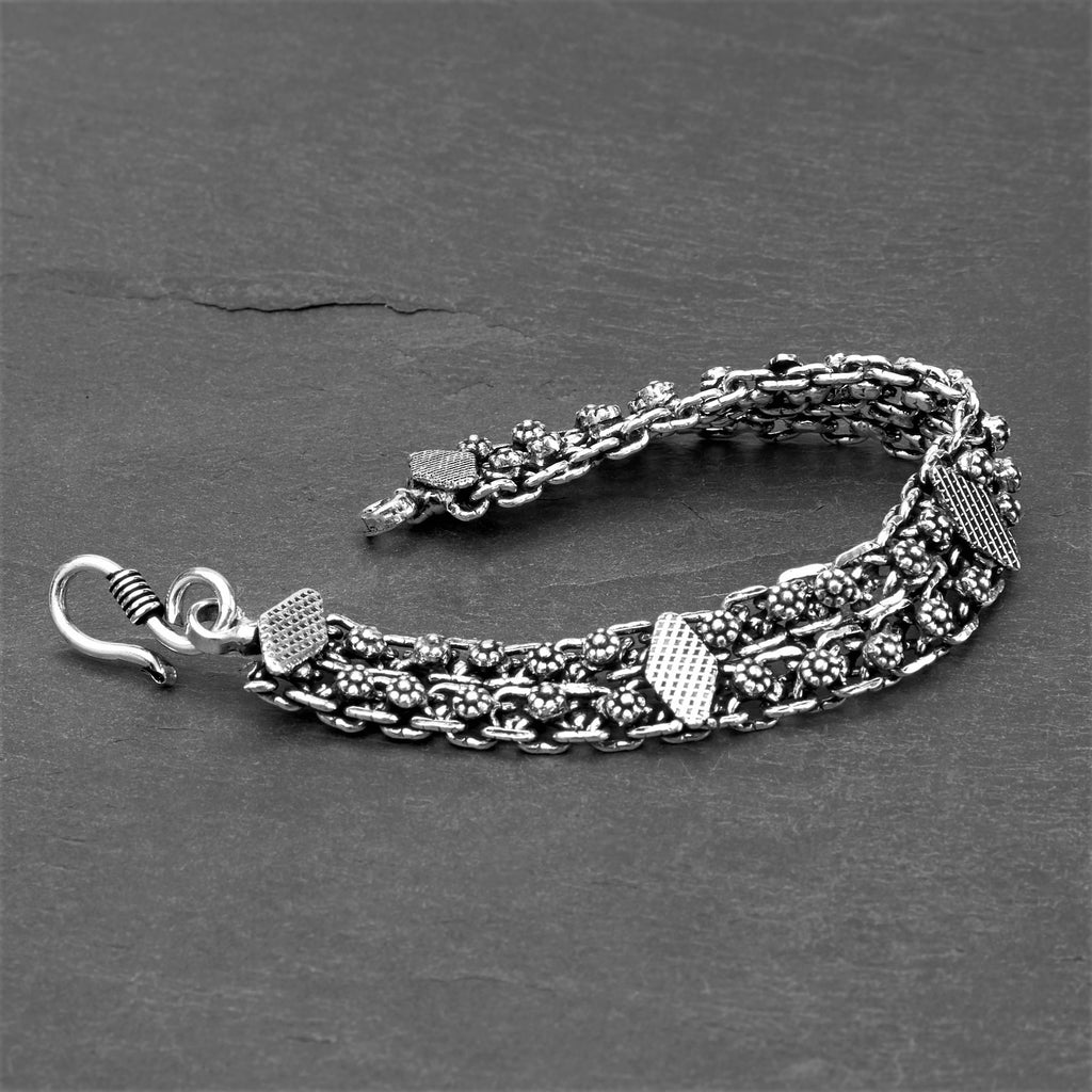 Artisan handmade oxidised silver, flower and diamond shaped charm, intricate chain bracelet designed by OMishka.
