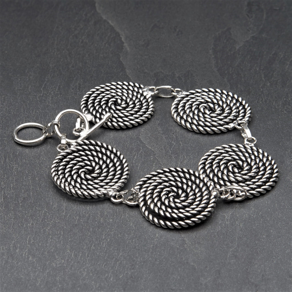 Artisan handmade silver toned brass, five coiled rope spiral detail, adjustable bracelet designed by OMishka.