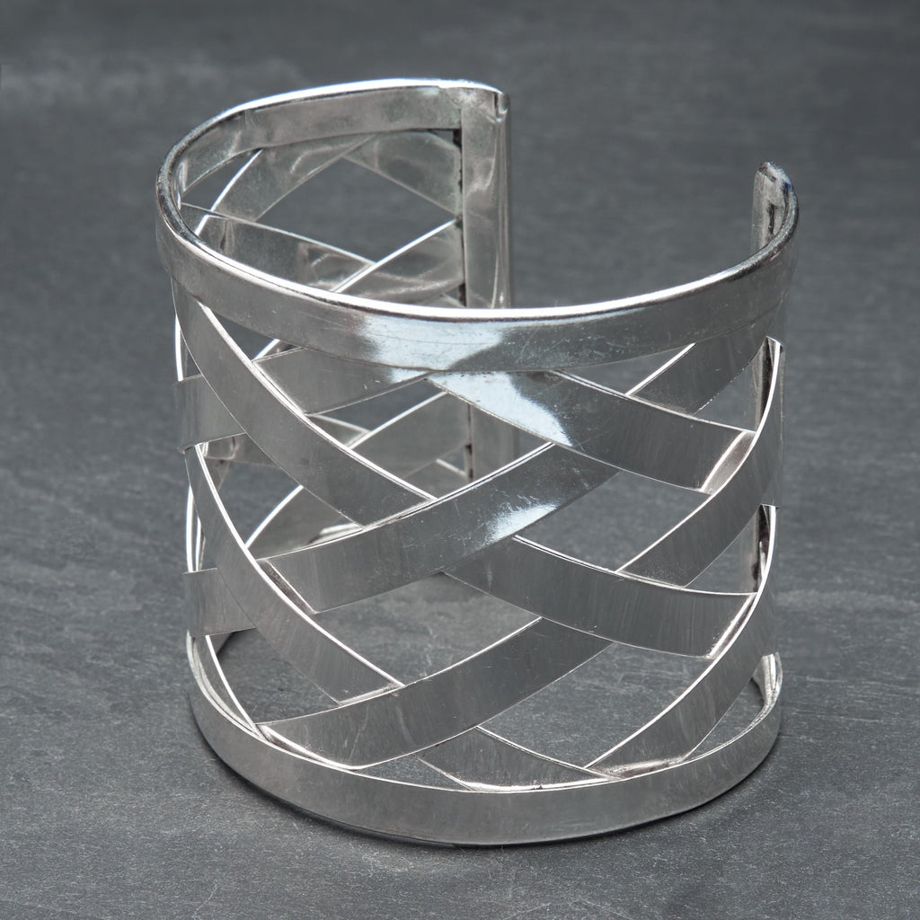 A wide artisan handmade silver, open lattice criss cross detailed cuff bracelet designed by OMishka.