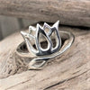 An artisan handmade solid silver, open lotus flower wrap ring designed by OMishka.