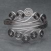 An artisan handmade silver open spiral armlet designed by OMishka.
