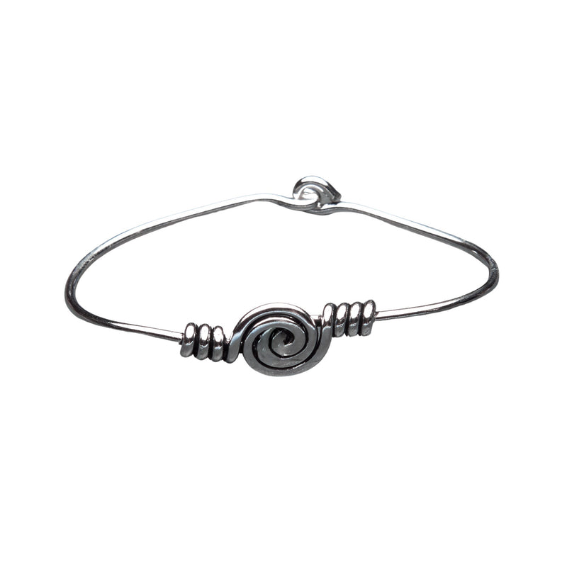 An artisan handmade, solid silver spiral patterned bangle bracelet designed by OMishka.