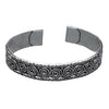 An artisan handmade, silver spiral patterned torque bracelet designed by OMishka.