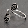 An artisan handmade,  solid silver open spiral wrap toe ring designed by OMishka.