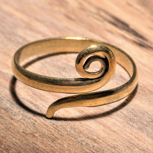 A simple, artisan handmade pure brass, single spiral wrap ring designed by OMishka.