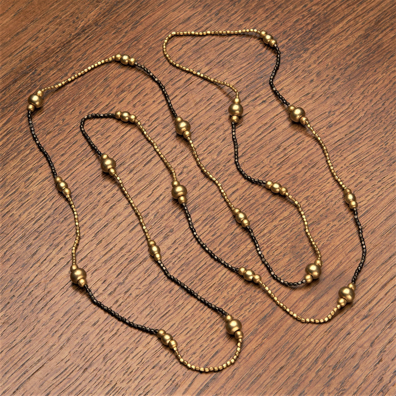 Artisan handmade, golden and black brass, striped beaded, long single strand necklace designed by OMishka.
