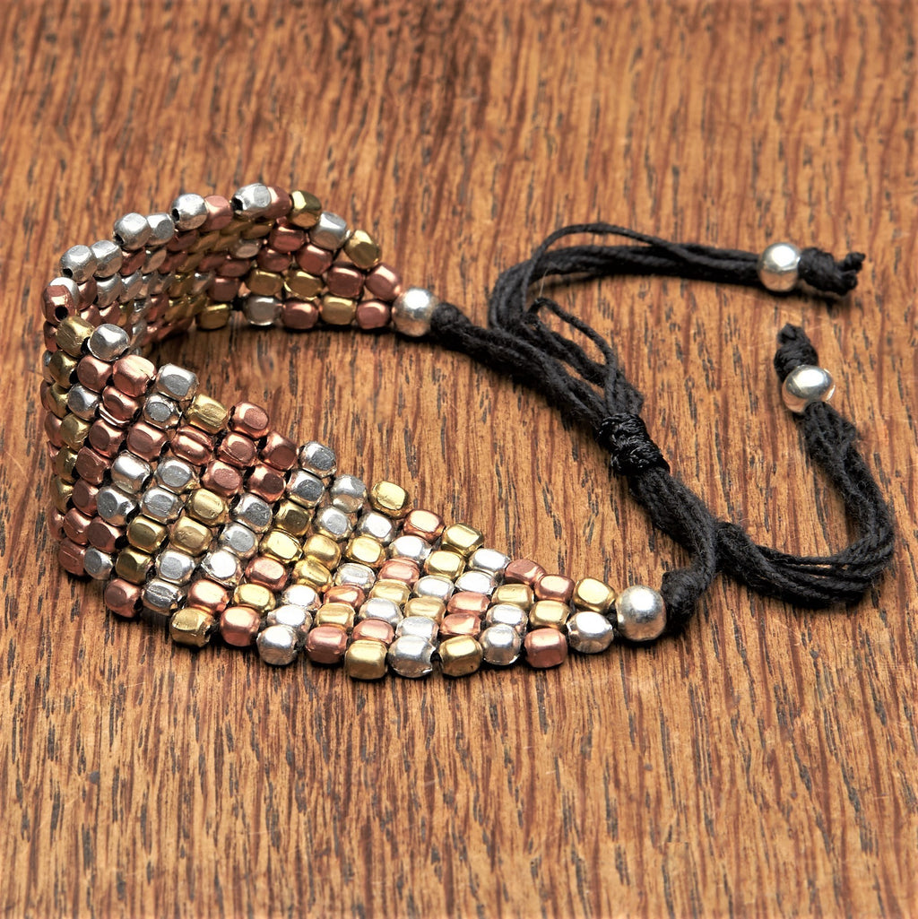 Artisan handmade three tone, silver, copper and pure brass woven bead bracelet designed by OMishka.