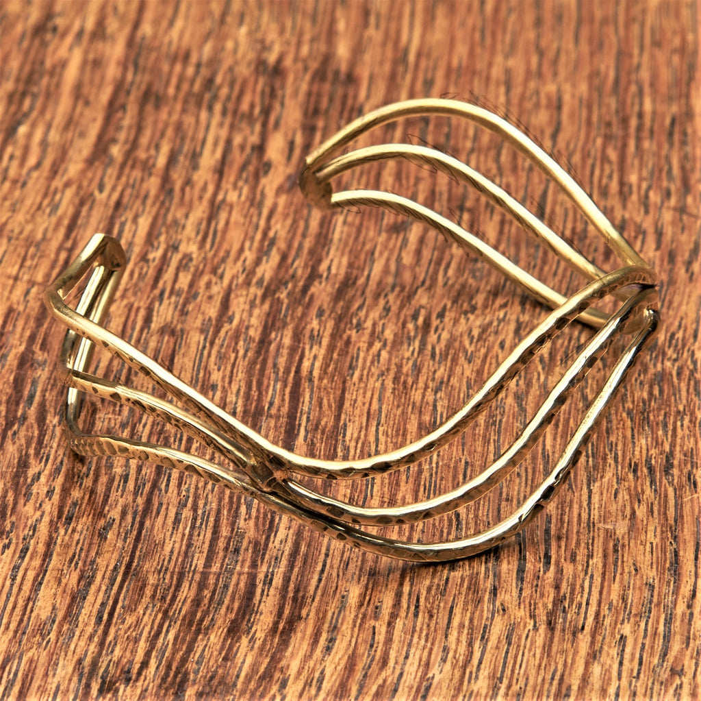 An artisan handmade, triple wave pure brass cuff bracelet designed by OMishka.
