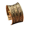 An artisan handmade, wide concave shaped pure brass striped patterned cuff bracelet designed by OMishka.