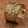 A wide artisan handmade pure brass, woven patterned cuff bracelet designed by OMishka.