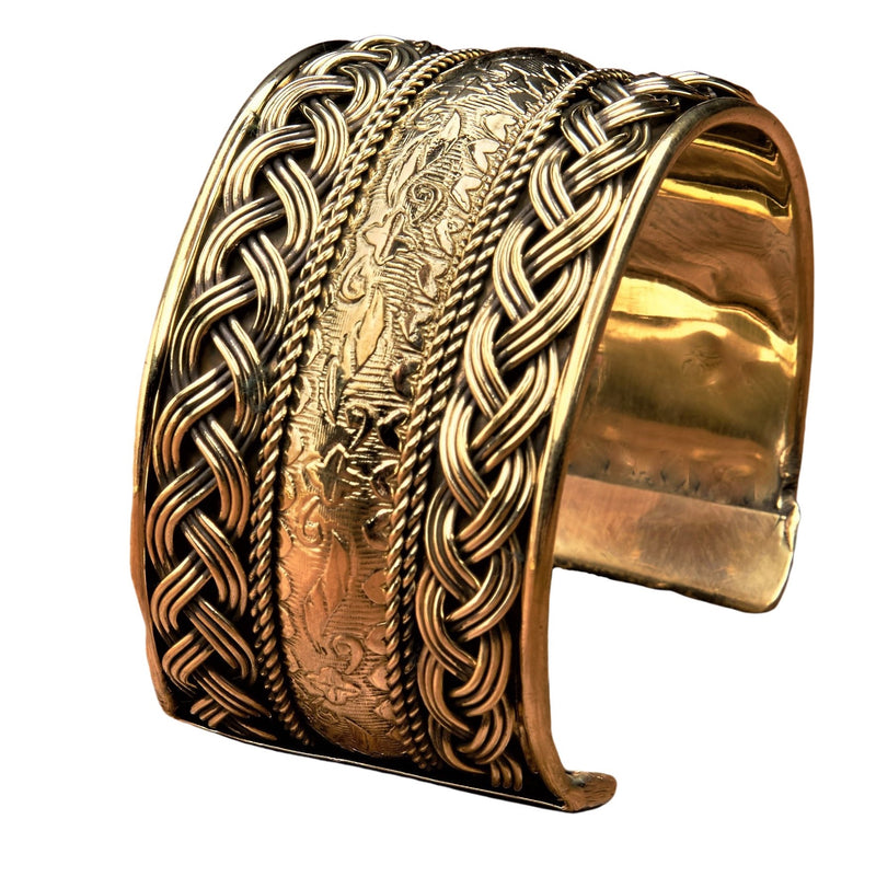 An artisan handmade, wide woven pure brass, floral patterned cuff bracelet designed by OMishka.