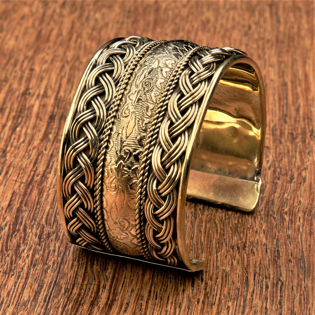 An artisan handmade, wide woven pure brass patterned cuff bracelet designed by OMishka.