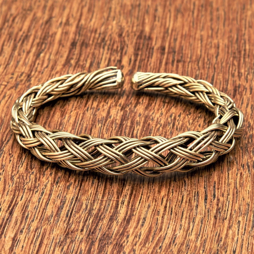 An artisan handmade, woven pure brass braid cuff bracelet designed by OMishka.