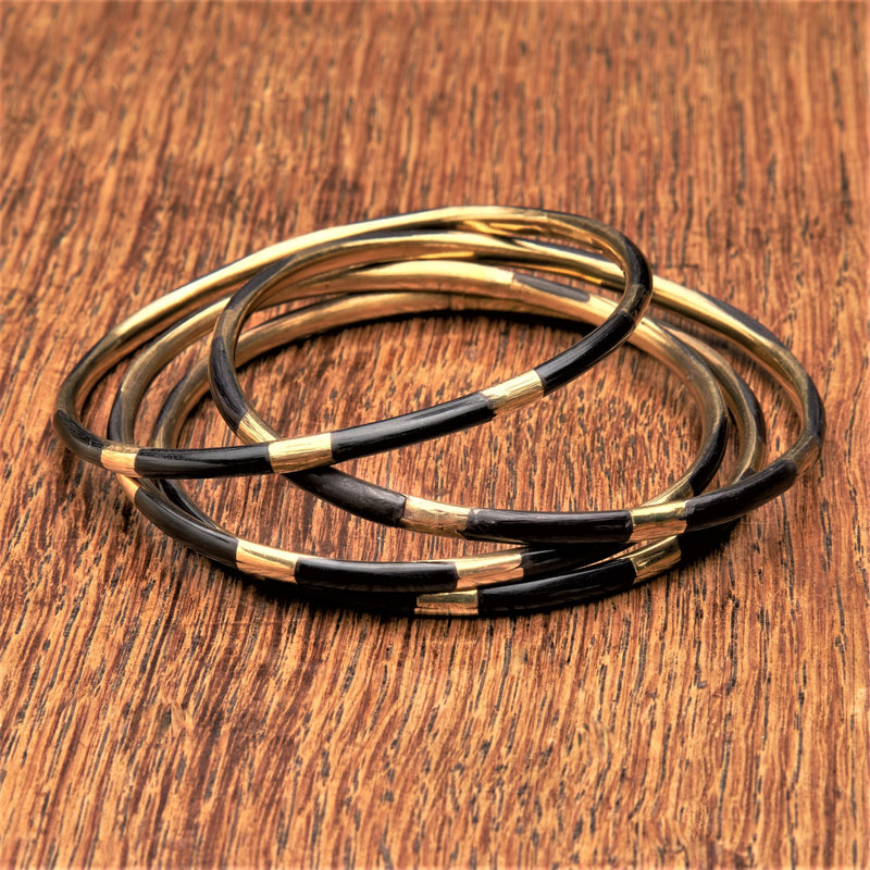 A set of 4 pure brass and black enamel striped thin bangles designed by OMishka.
