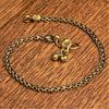 A chunky, nickel free pure brass, boxed chain ankle bracelet with tiny bells designed by OMishka.