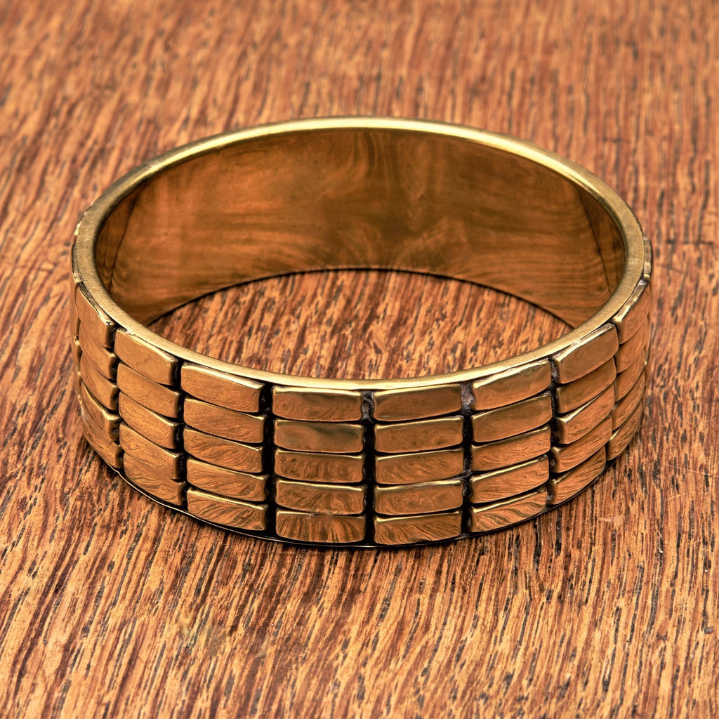 A chunky, patterned pure brass bangle bracelet designed by OMishka.
