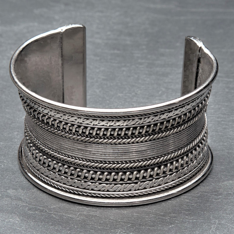 A concave, patterned silver cuff bracelet designed by OMishka.