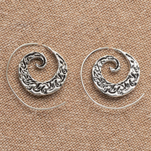Handmade nickel free solid silver, dainty swirl patterned spiral hoop earrings designed by OMishka.