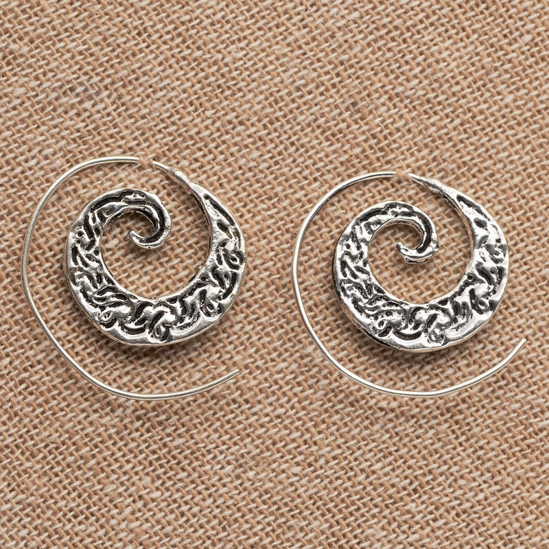 Handmade nickel free solid silver, dainty swirl patterned spiral hoop earrings designed by OMishka.